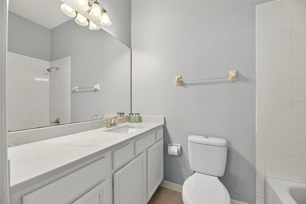 5720 Tortoise Place Apollo Beach, FL 33572 - Photo 40 of 83 a bathroom with a toilet a sink and mirror