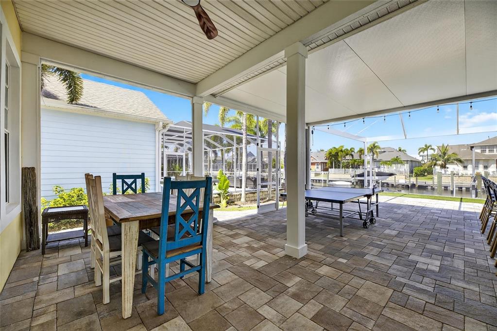 5720 Tortoise Place Apollo Beach, FL 33572 - Photo 47 of 83 a view of a patio with table and chairs and floor to ceiling window