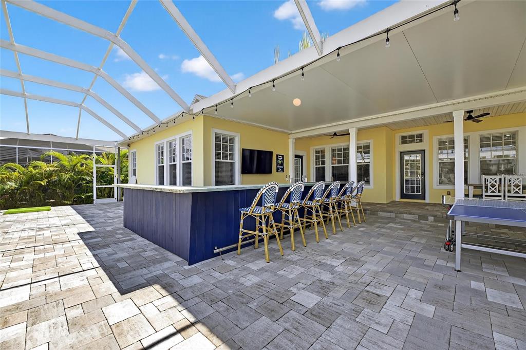 5720 Tortoise Place Apollo Beach, FL 33572 - Photo 5 of 83 a view of a patio with table and chairs potted plants with wooden floor