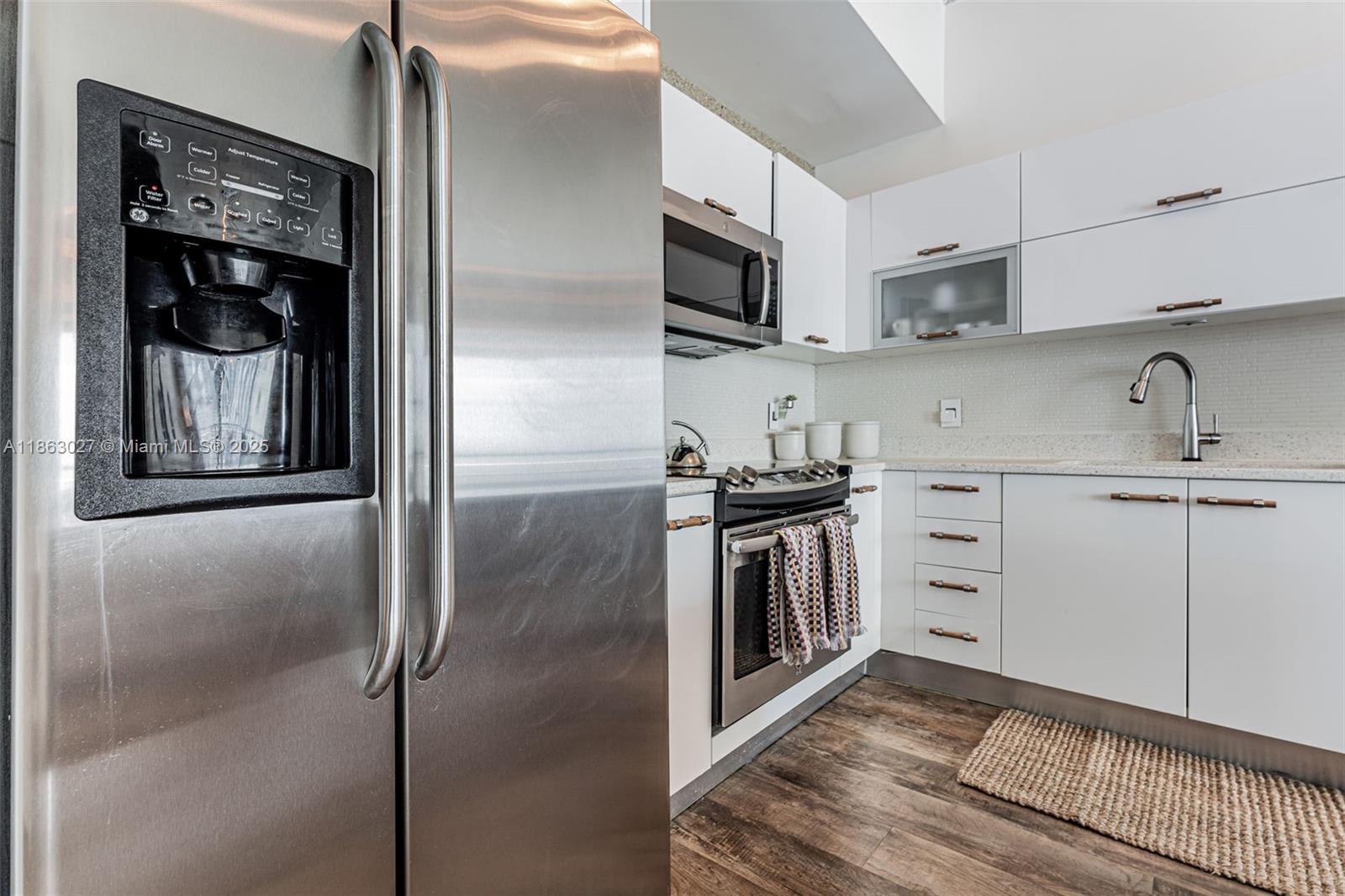 133 Northeast 2nd Avenue, Unit 1208 Miami, FL 33132 - Photo 11 of 33 a kitchen with stainless steel appliances granite countertop a refrigerator and a sink