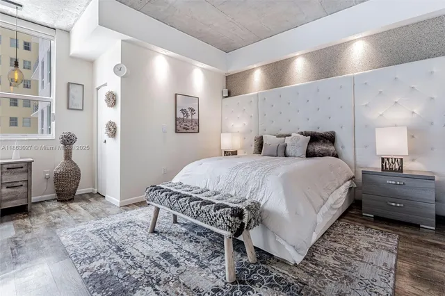 a spacious bedroom with a bed a table and chair