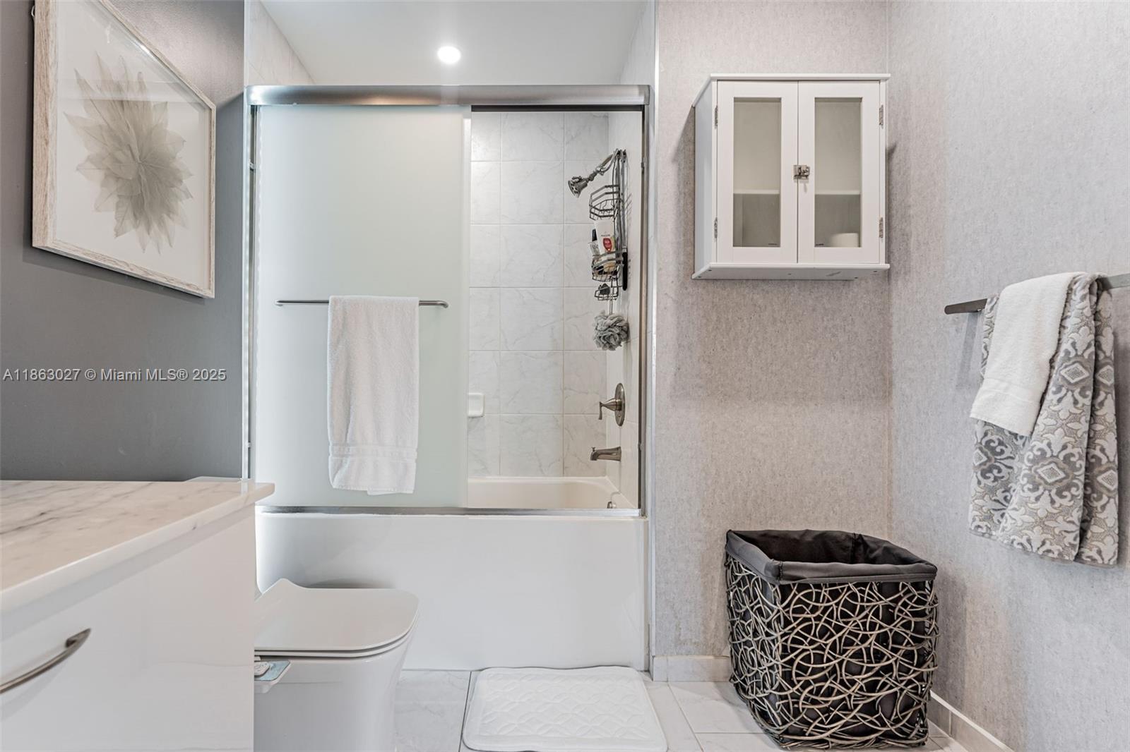 133 Northeast 2nd Avenue, Unit 1208 Miami, FL 33132 - Photo 21 of 33 a bathroom with a shower toilet and a window