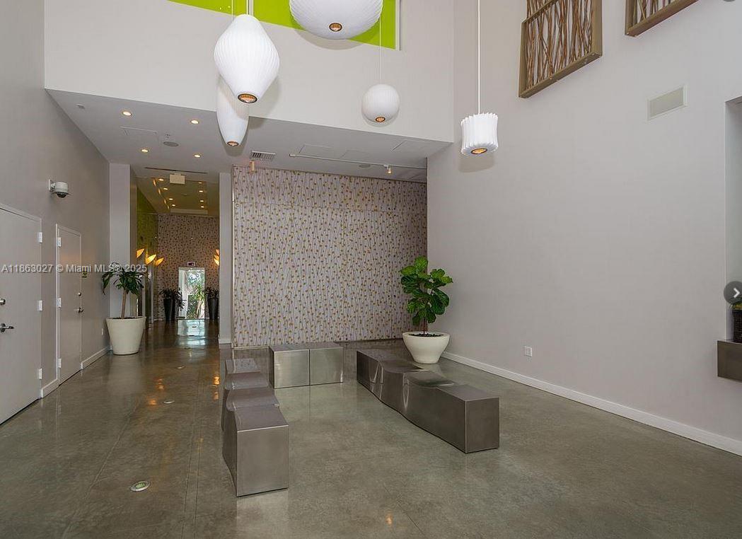 133 Northeast 2nd Avenue, Unit 1208 Miami, FL 33132 - Photo 27 of 33 a lobby with furniture and potted plant