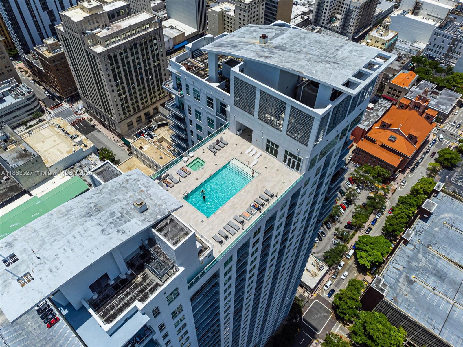 133 Northeast 2nd Avenue, Unit 1208 Miami, FL 33132 - Photo 33 of 33 a view of a patio with table and chairs with wooden floor and fence