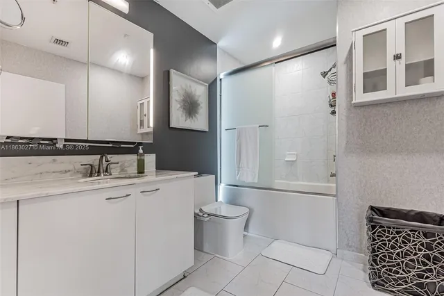 a kitchen with stainless steel appliances granite countertop a stove top oven a refrigerator a sink dishwasher with a dining table and chairs