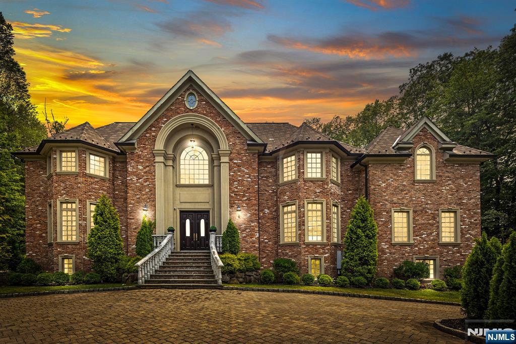 a view of a brick house with a clock on the side of a house