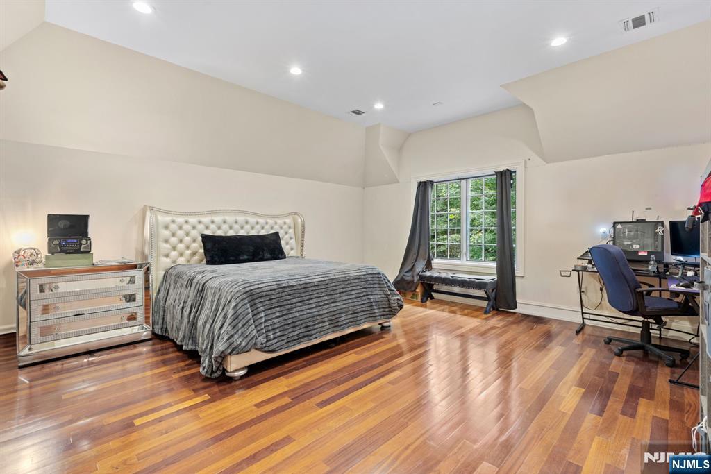 146 East Allendale Road Saddle River, NJ 07458 - Photo 14 of 28 a bedroom with a bed and a chair