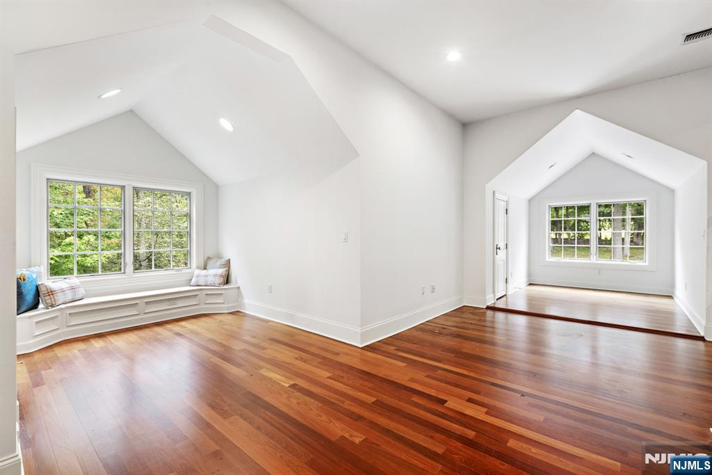 146 East Allendale Road Saddle River, NJ 07458 - Photo 18 of 28 an empty room with wooden floor and windows