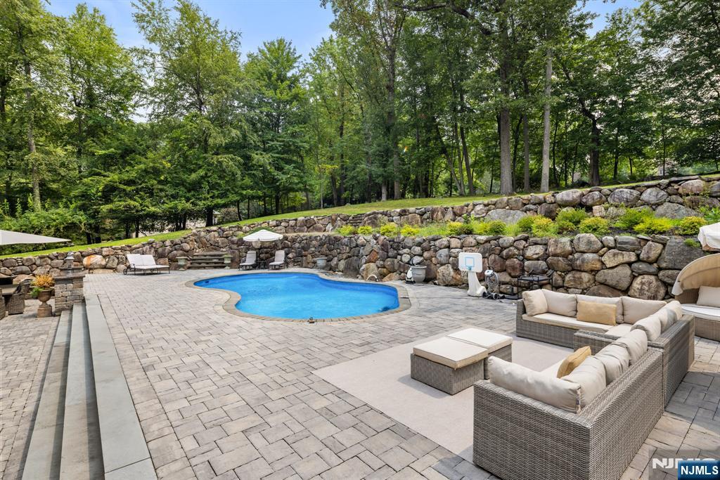 146 East Allendale Road Saddle River, NJ 07458 - Photo 23 of 28 a view of a swimming pool with a patio