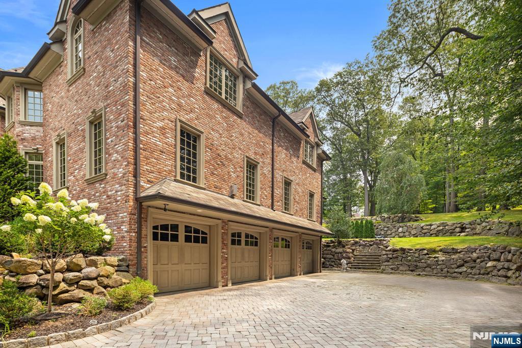 146 East Allendale Road Saddle River, NJ 07458 - Photo 26 of 28 a view of a house with a yard and plants