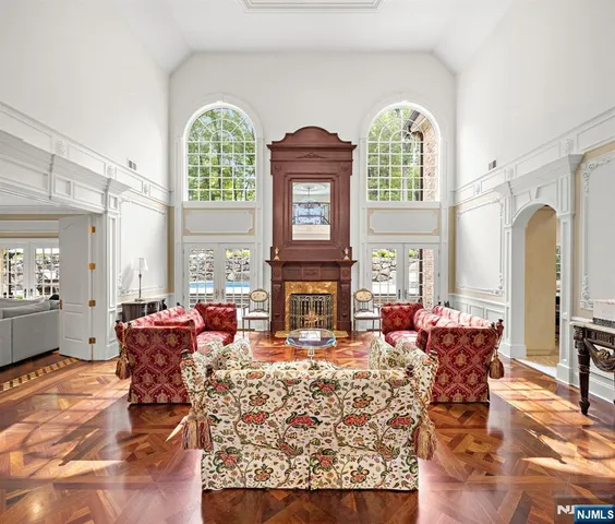 a living room with furniture a fireplace and a large window