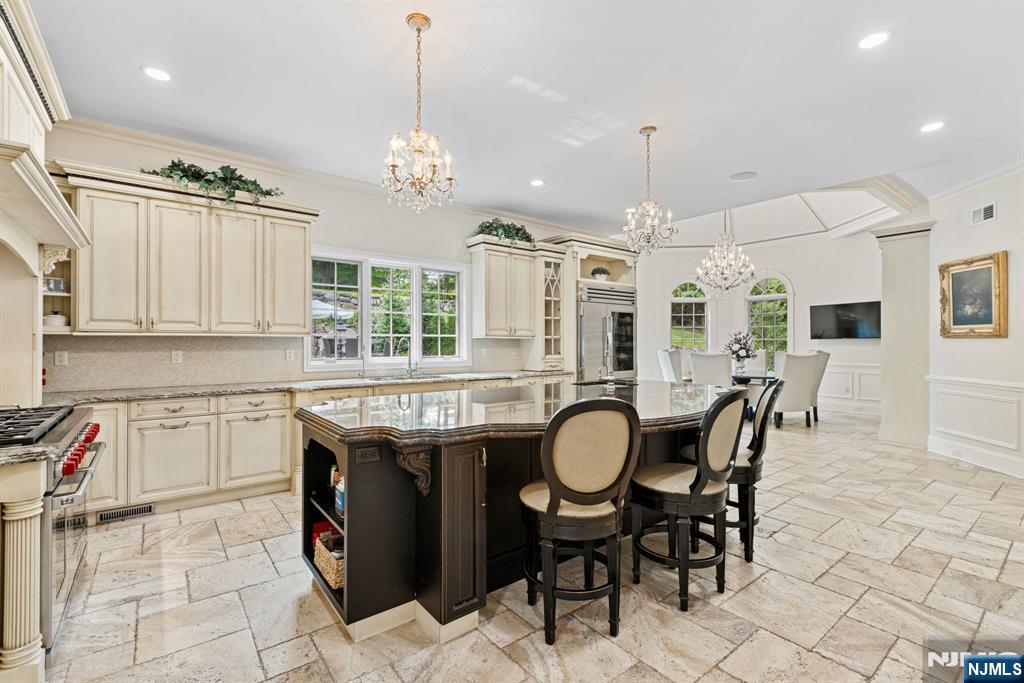146 East Allendale Road Saddle River, NJ 07458 - Photo 4 of 28 a kitchen with granite countertop a sink a counter space appliances and cabinets