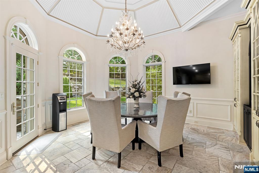 146 East Allendale Road Saddle River, NJ 07458 - Photo 6 of 28 a view of a dining room with furniture and chandelier