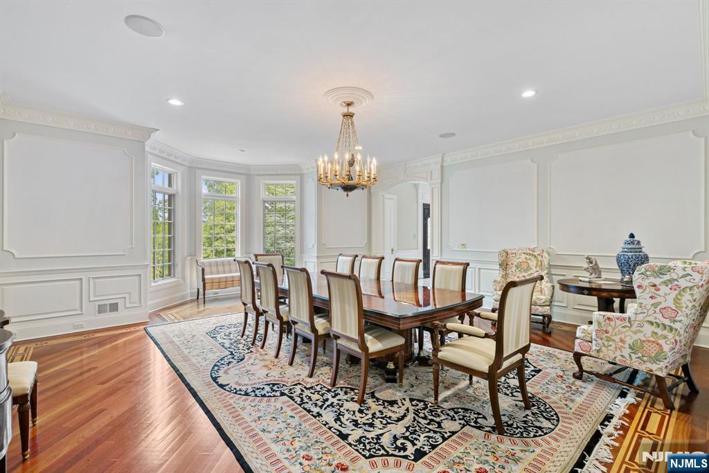 146 East Allendale Road Saddle River, NJ 07458 - Photo 7 of 28 a dining room with furniture a chandelier and wooden floor