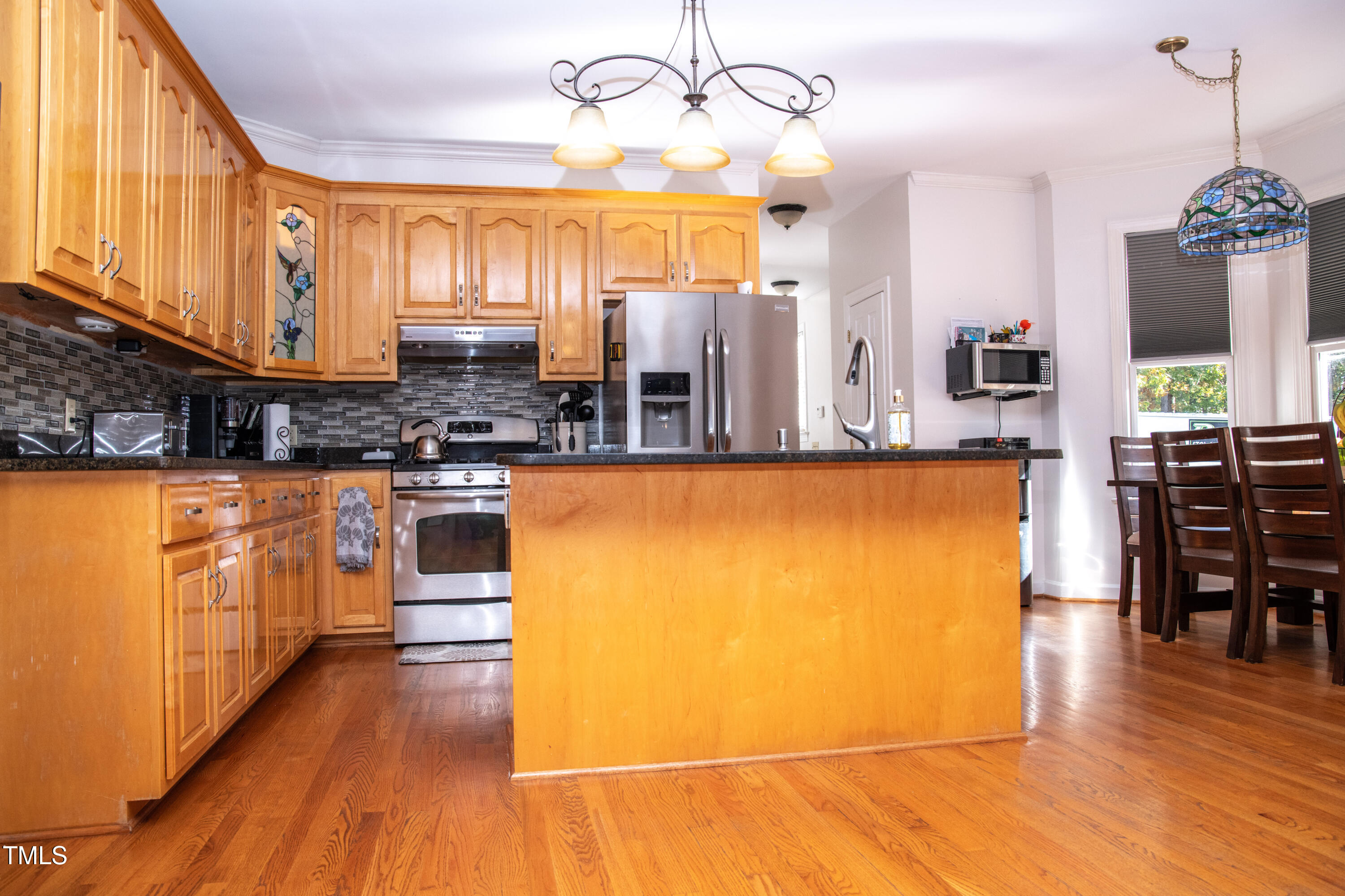 253 Cothran Hicks Road Rougemont, NC 27572 - Photo 21 of 48 a view of a kitchen with wooden floor and stainless steel appliances