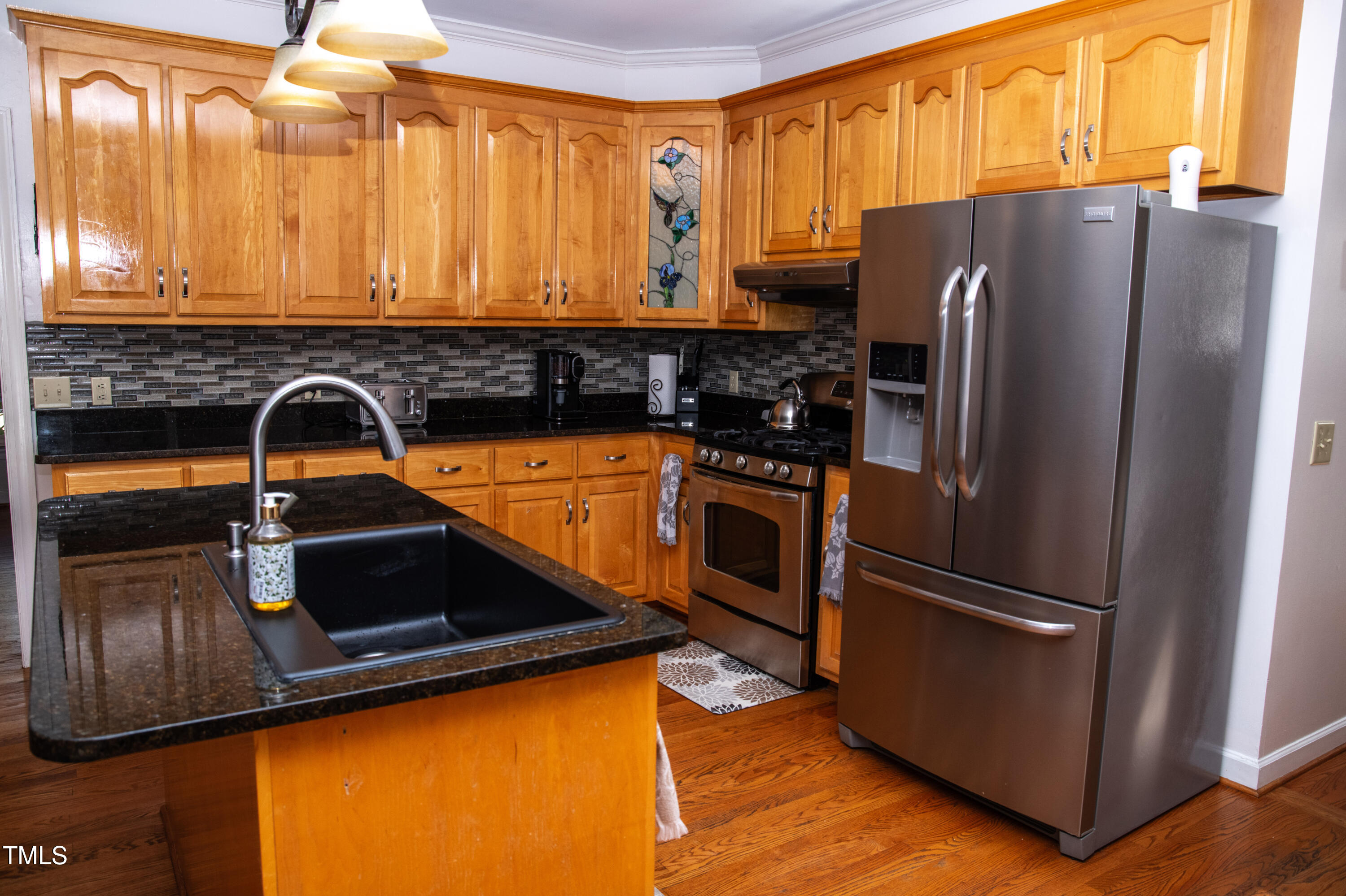 253 Cothran Hicks Road Rougemont, NC 27572 - Photo 22 of 48 a kitchen with stainless steel appliances a refrigerator and a sink