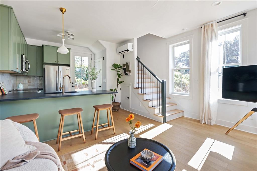 1160 Boulevard Southeast, Unit 11 Atlanta, GA 30312 - Photo 11 of 32 a living room with furniture a flat screen tv and a large window