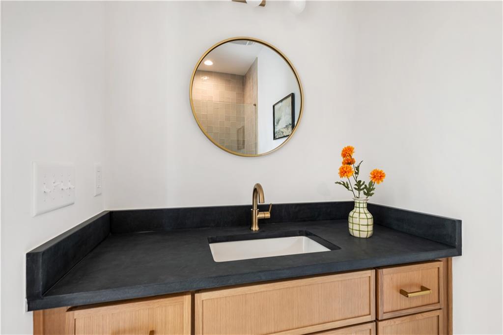 1160 Boulevard Southeast, Unit 11 Atlanta, GA 30312 - Photo 17 of 32 a bathroom with a sink and a mirror