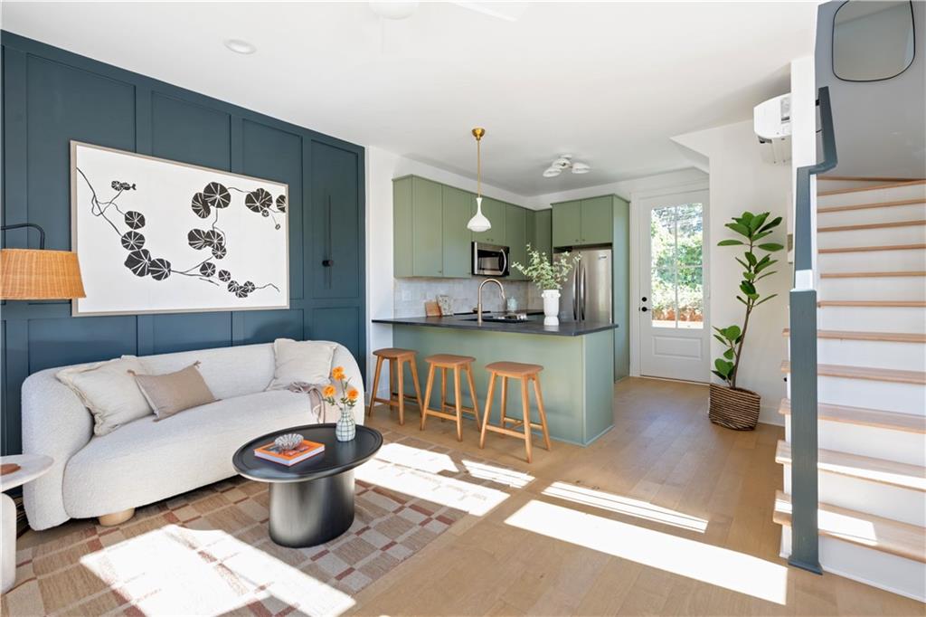 1160 Boulevard Southeast, Unit 11 Atlanta, GA 30312 - Photo 3 of 32 a living room with furniture and a painting on the wall