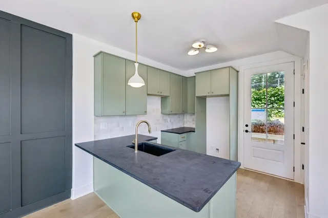 a kitchen with a sink cabinets and appliances