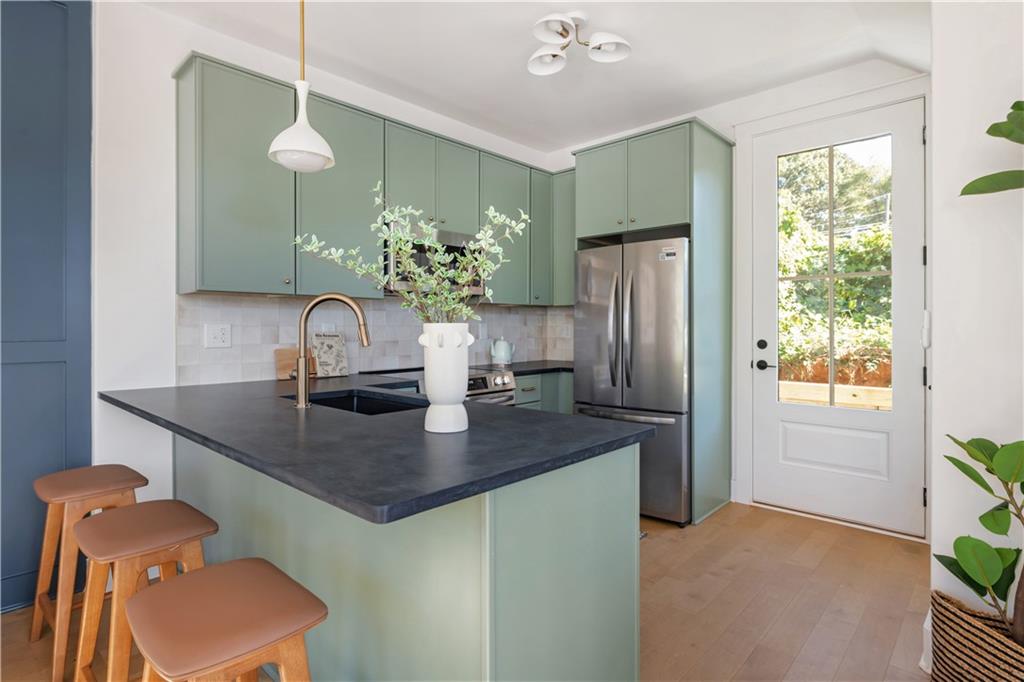 1160 Boulevard Southeast, Unit 11 Atlanta, GA 30312 - Photo 5 of 32 a kitchen with stainless steel appliances granite countertop a refrigerator and a sink