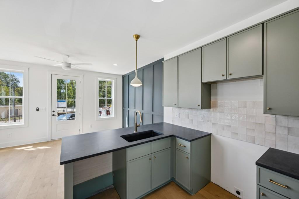 1160 Boulevard Southeast, Unit 11 Atlanta, GA 30312 - Photo 7 of 32 a kitchen with stainless steel appliances white cabinets a sink and a large window
