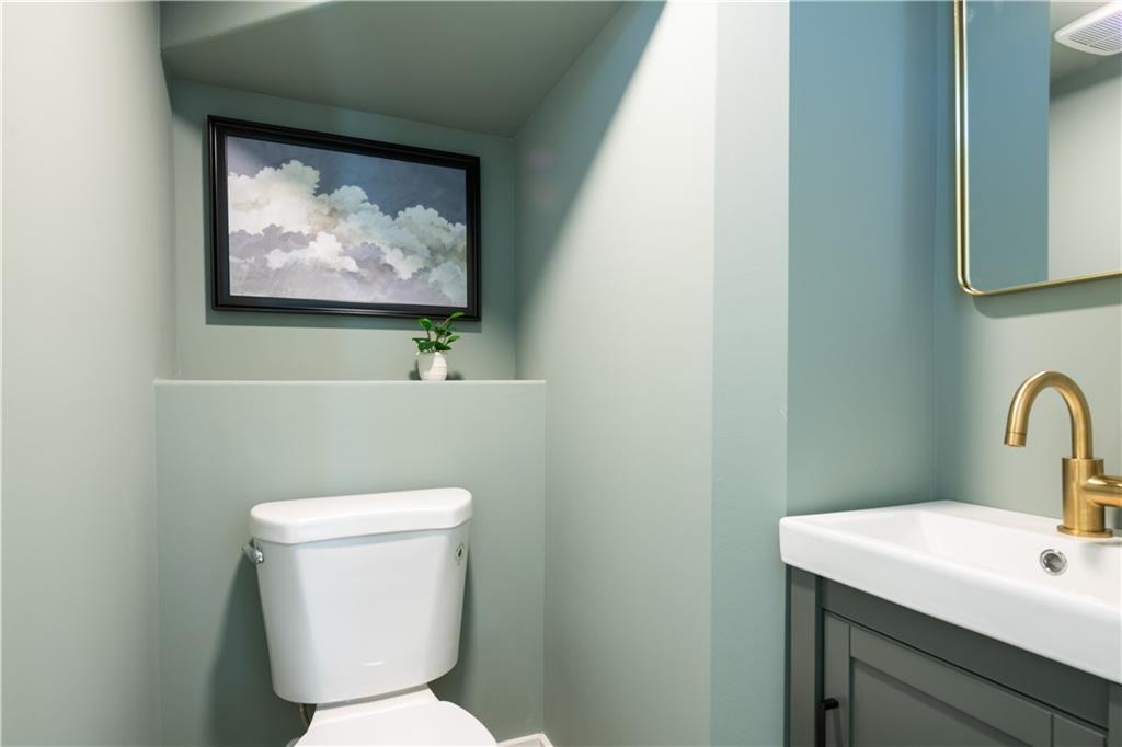 1160 Boulevard Southeast, Unit 11 Atlanta, GA 30312 - Photo 8 of 32 a bathroom with a toilet a sink and mirror