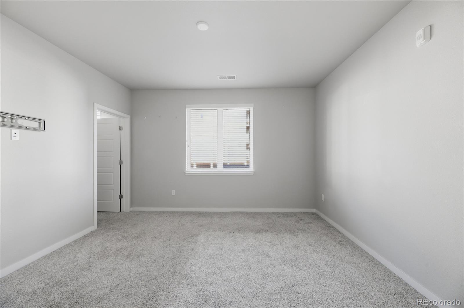 9291 Twenty Mile Road, Unit 207 Parker, CO 80134 - Photo 17 of 25 a view of an empty room with a window