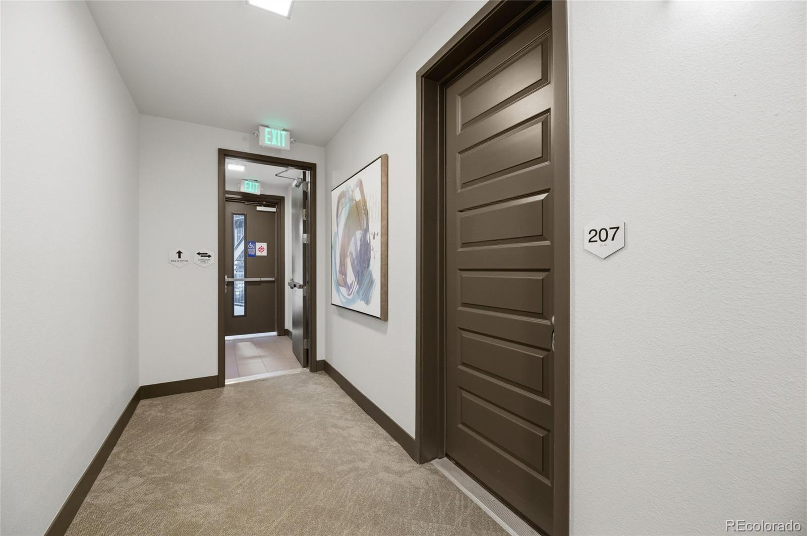 9291 Twenty Mile Road, Unit 207 Parker, CO 80134 - Photo 2 of 25 a view of hallway with stairs and wooden floor