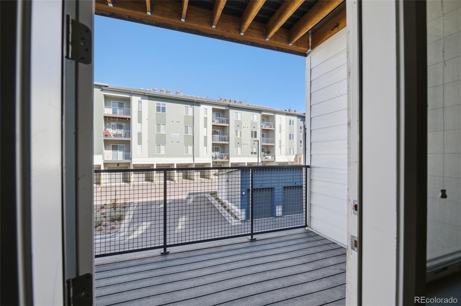 9291 Twenty Mile Road, Unit 207 Parker, CO 80134 - Photo 21 of 25 a view of a balcony with wooden floor