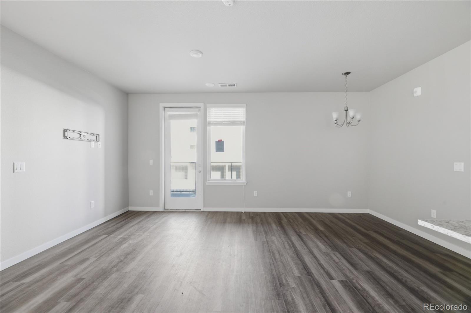 9291 Twenty Mile Road, Unit 207 Parker, CO 80134 - Photo 7 of 25 wooden floor in an empty room