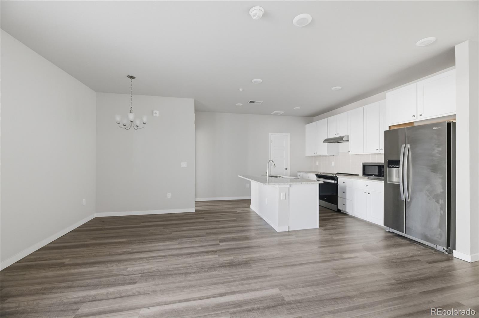 9291 Twenty Mile Road, Unit 207 Parker, CO 80134 - Photo 8 of 25 a view of kitchen with wooden floor