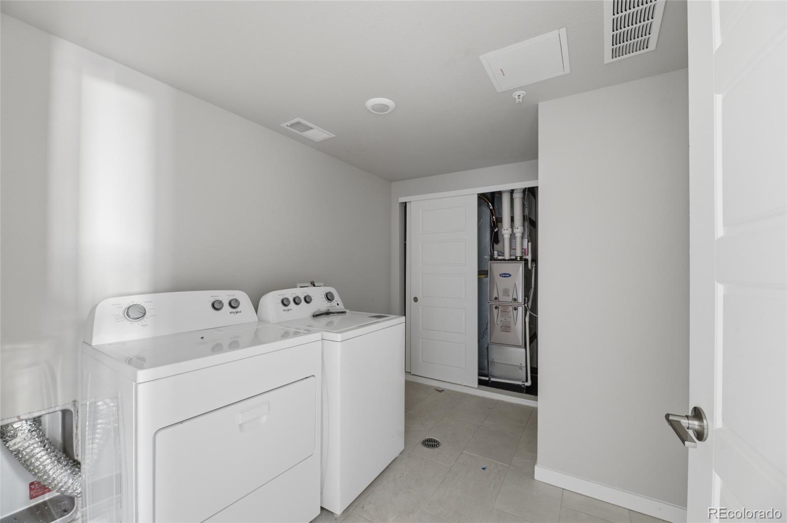 9291 Twenty Mile Road, Unit 207 Parker, CO 80134 - Photo 9 of 25 a utility room with dryer and washer