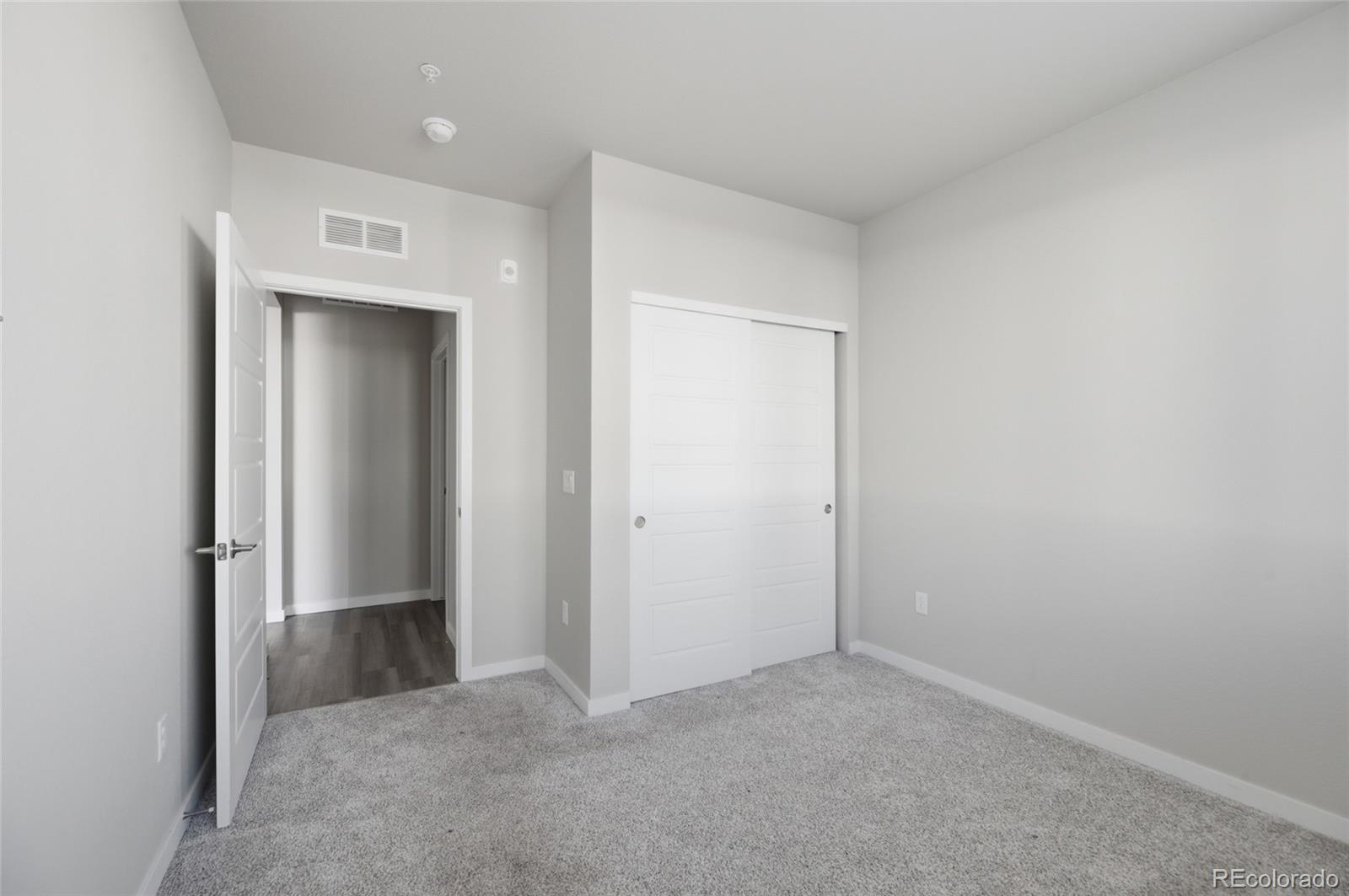 9291 Twenty Mile Road, Unit 207 Parker, CO 80134 - Photo 10 of 25 a view of an empty room with closet and a window