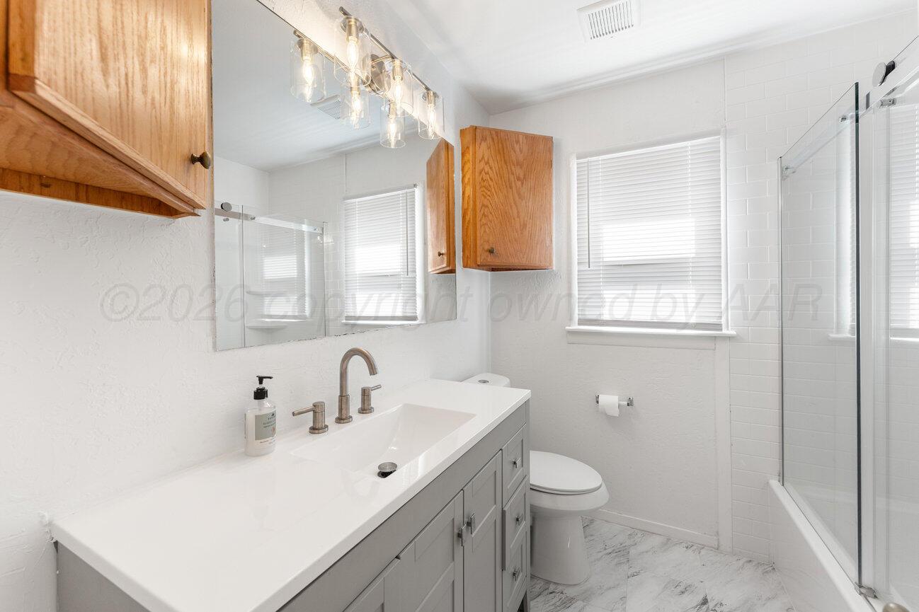 1109 Callahan Street Amarillo, TX 79106 - Photo 17 of 23 a bathroom with a toilet sink and mirror