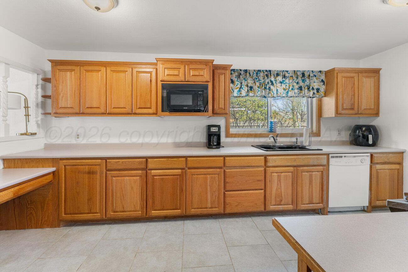 1109 Callahan Street Amarillo, TX 79106 - Photo 2 of 23 a kitchen with stainless steel appliances granite countertop a sink dishwasher stove top oven and cabinets