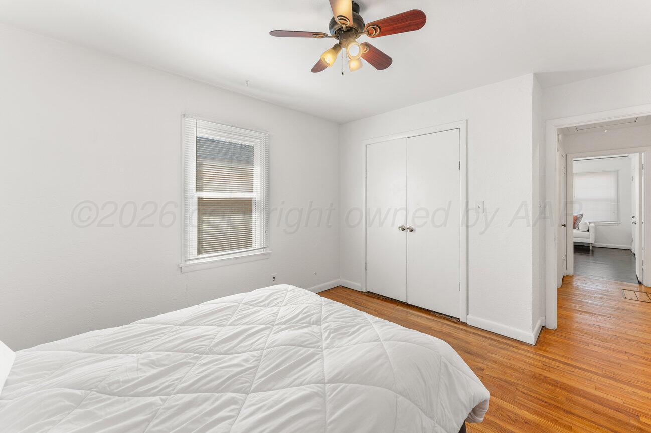 1109 Callahan Street Amarillo, TX 79106 - Photo 7 of 23 a bedroom with a bed and wooden floor