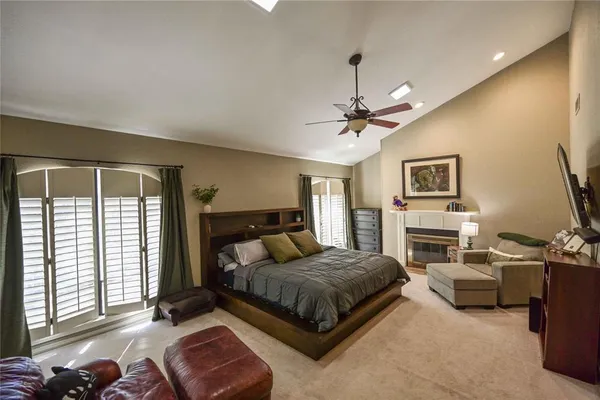a bedroom with a bed couch and flat screen tv