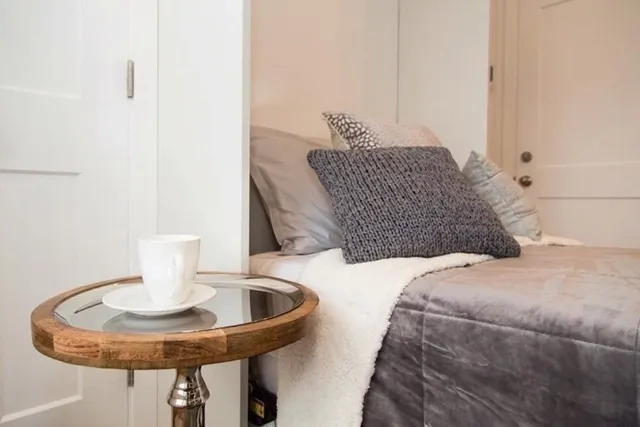 a bedroom with a bed and chandelier