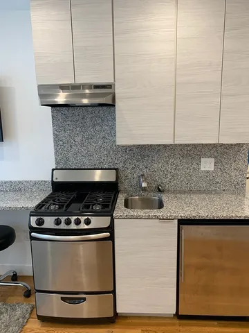 a stove top oven sitting inside of a kitchen