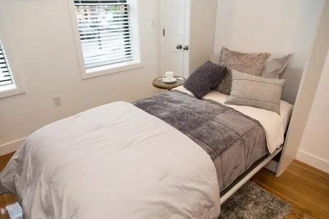 a bedroom with a bed and a window