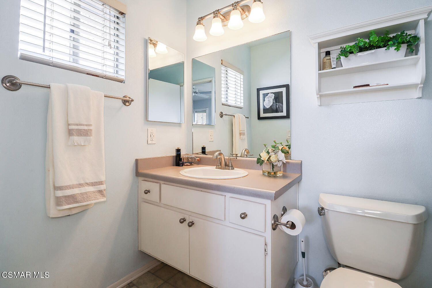 4498 Apricot Road, Unit B Simi Valley, CA 93063 - Photo 19 of 36 a bathroom with a toilet sink and mirror