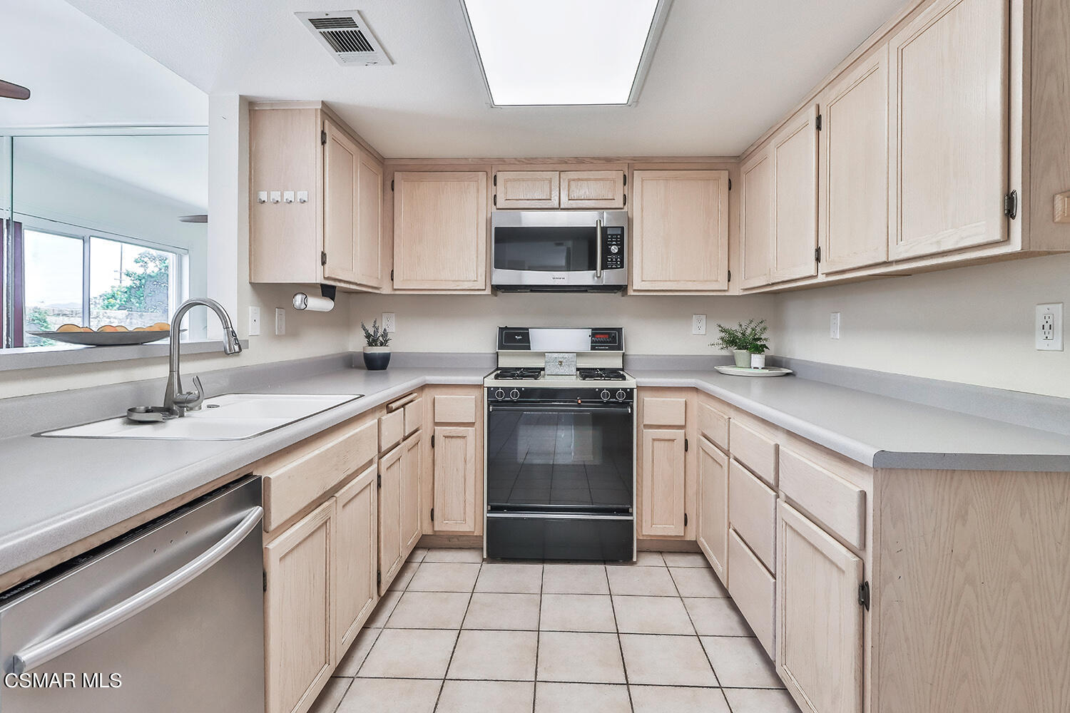 4498 Apricot Road, Unit B Simi Valley, CA 93063 - Photo 6 of 36 a kitchen with stainless steel appliances granite countertop a sink and dishwasher a stove top oven with white cabinets