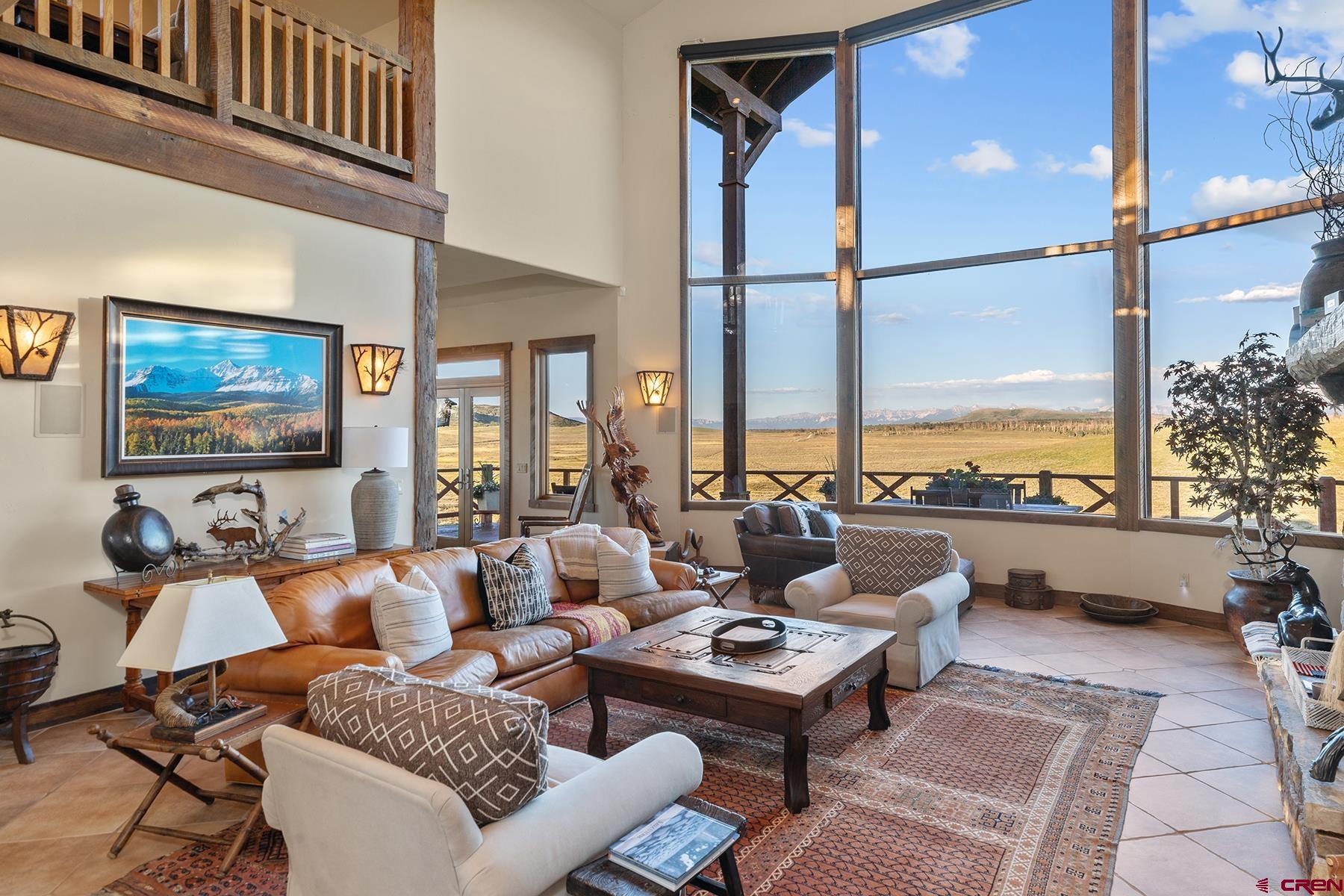 4234 Brown Ranch Road Placerville, CO 81430 - Photo 5 of 16 a living room with furniture fireplace and a large window