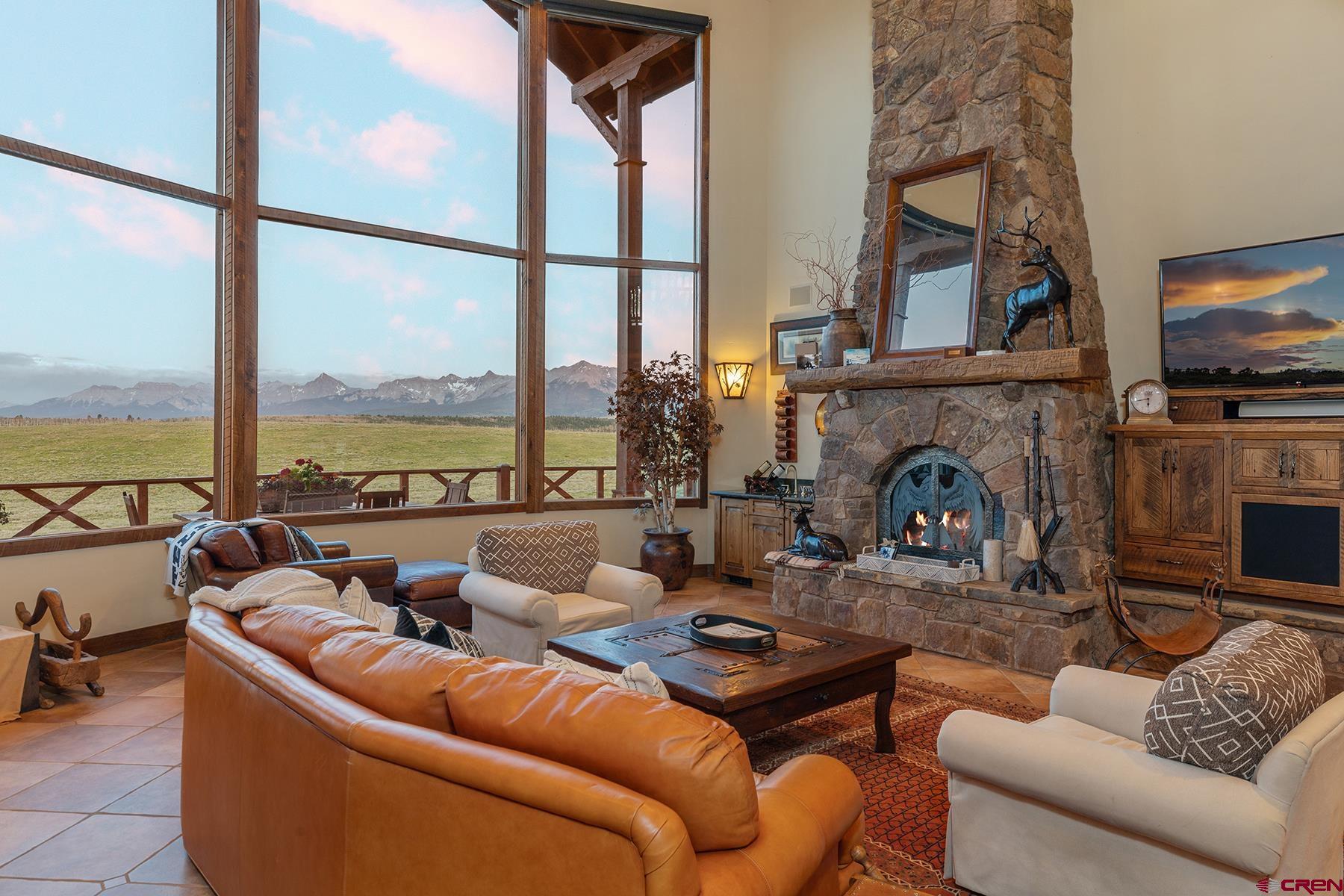 4234 Brown Ranch Road Placerville, CO 81430 - Photo 6 of 16 a living room with furniture a large window and a flat screen tv