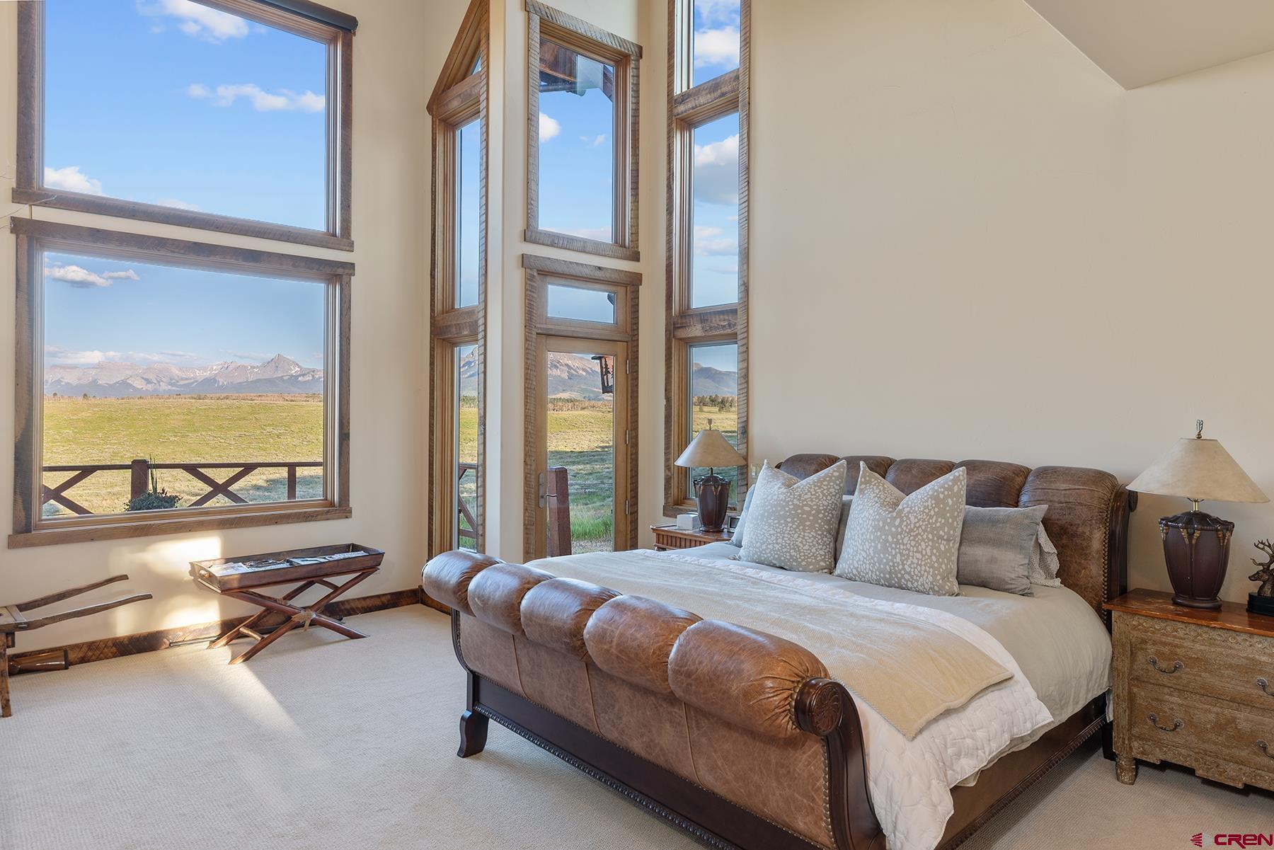 4234 Brown Ranch Road Placerville, CO 81430 - Photo 9 of 16 a bedroom with a bed and large windows