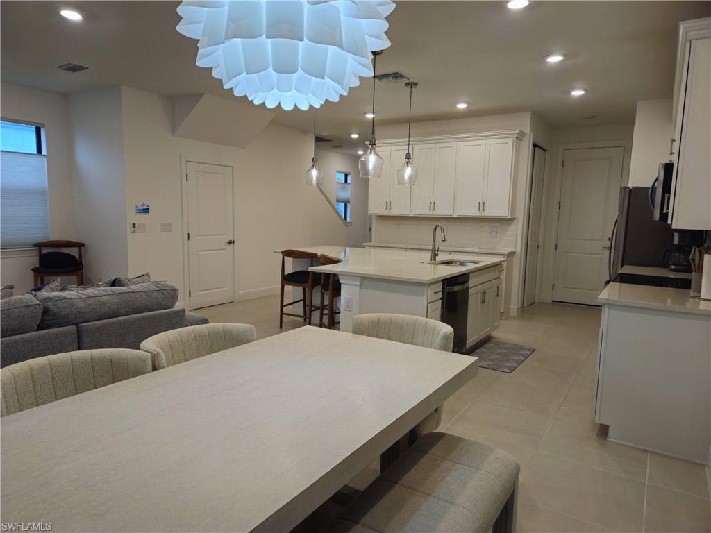 Undisclosed Address Naples, FL 34119 - Photo 14 of 50 a large kitchen with kitchen island a island a sink a stove and a refrigerator