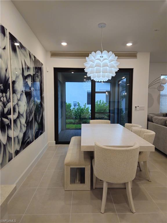 Undisclosed Address Naples, FL 34119 - Photo 17 of 50 a view of a dining room with furniture and chandelier