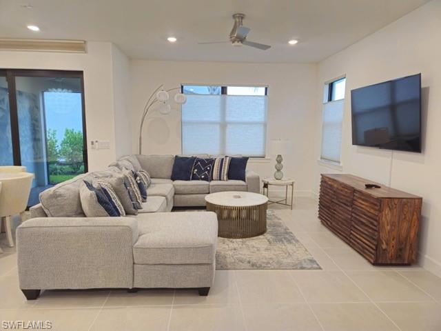 Undisclosed Address Naples, FL 34119 - Photo 18 of 50 a living room with furniture a large window and a flat screen tv