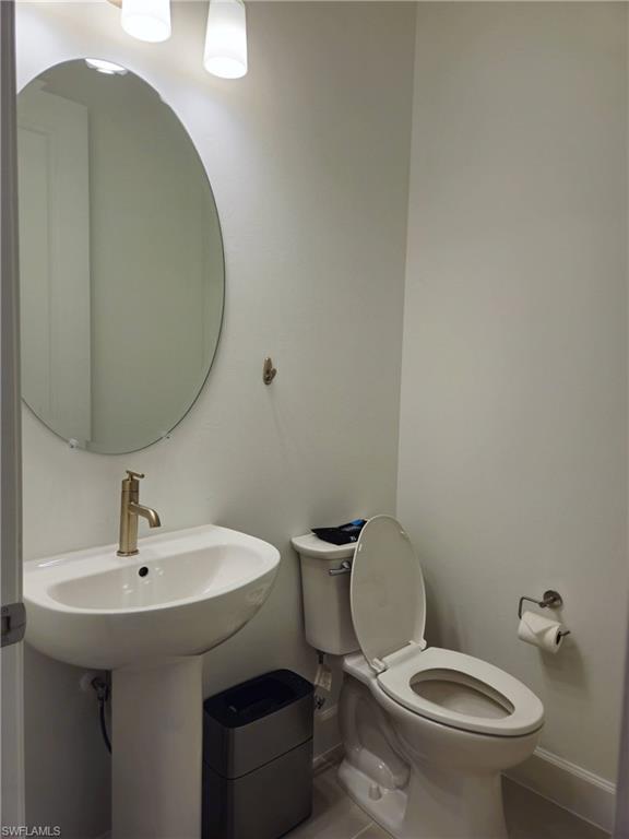 Undisclosed Address Naples, FL 34119 - Photo 19 of 50 a bathroom with a toilet and a sink